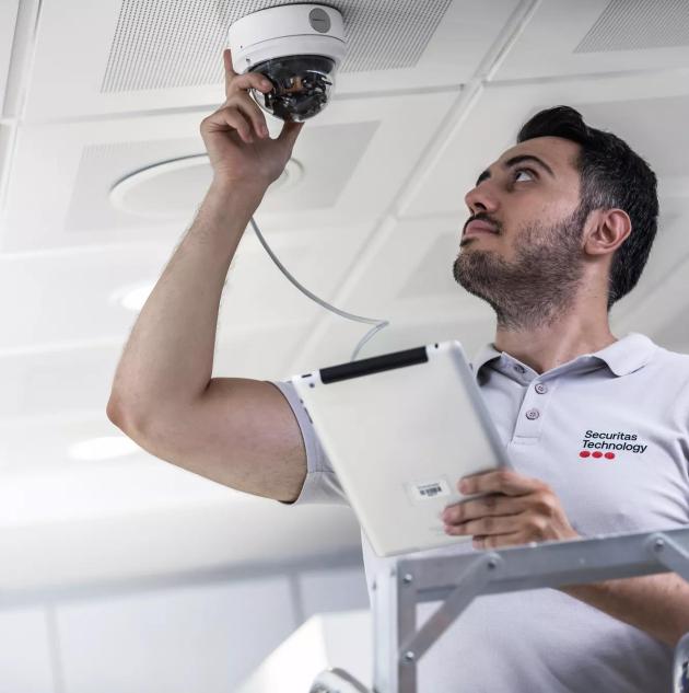 Securitas technician installing security camera