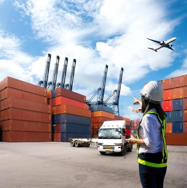 Foreman Woman control loading Containers box from Cargo freight ship for import export.