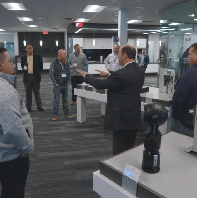 A group of clients being given a tour of the Securitas Technology Client Engagement Center in Ohio, US.
