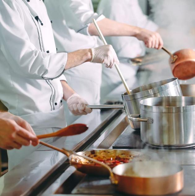Chef cooking vegetables in wok pan. Shallow dof