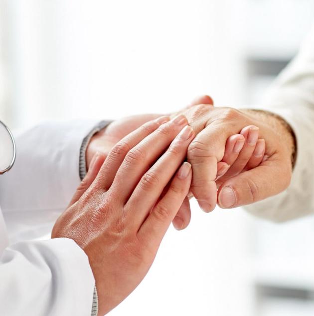 Doctor holds hands of patient