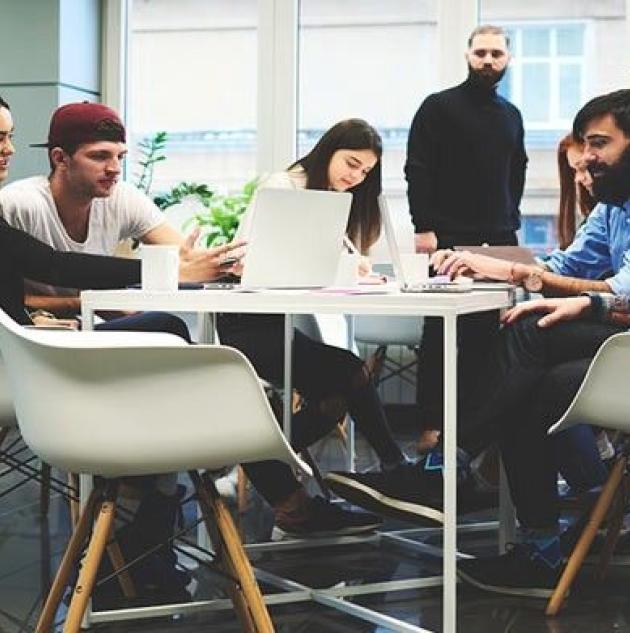 Employees work at a round table