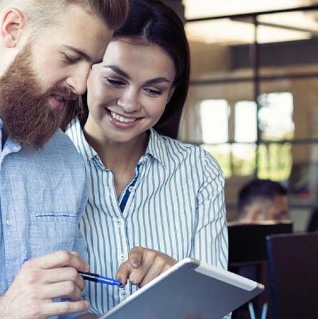 Two people look at clipboard