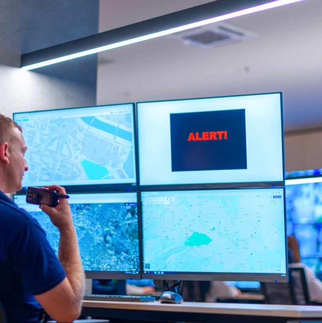 Monitoring centre employee uses walkie-talkie