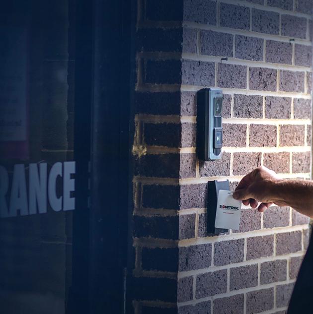 Man uses access control card reader to enter building