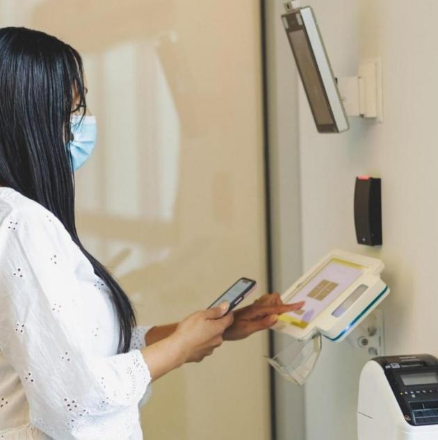 Woman using biometric access control system