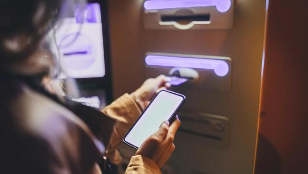 Entering a card in ATM machine at a bank