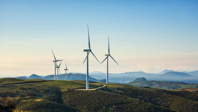Wind turbines on a beautiful blue sky in a mountain wind farm in Sardinia. Renewable energy concept, green energy generation. Energy industry.
