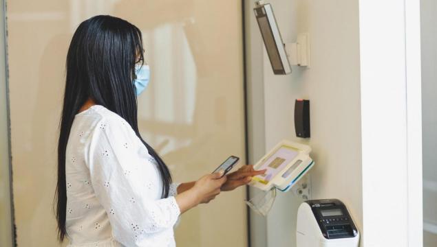 Woman using biometric access control system