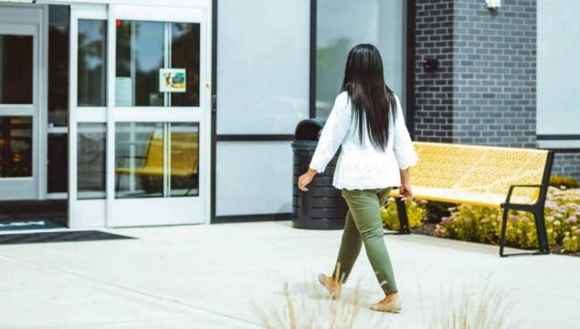 women entering building through door access control system