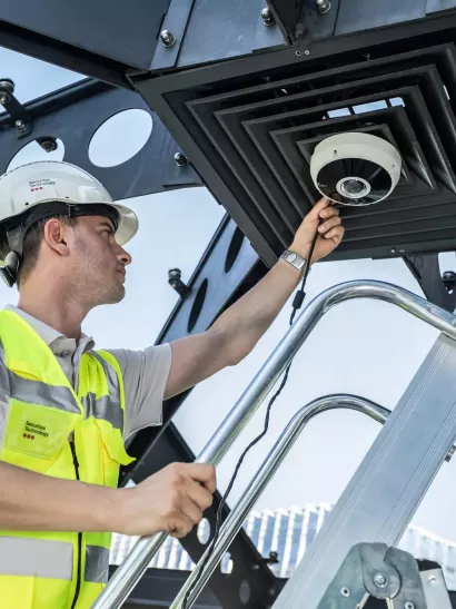 security technician installing business security camera