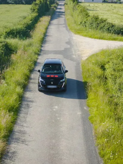 a car with the Securitas Technology logo driving down a road, showcasing the company's mobile service capabilities and rapid response commitment.