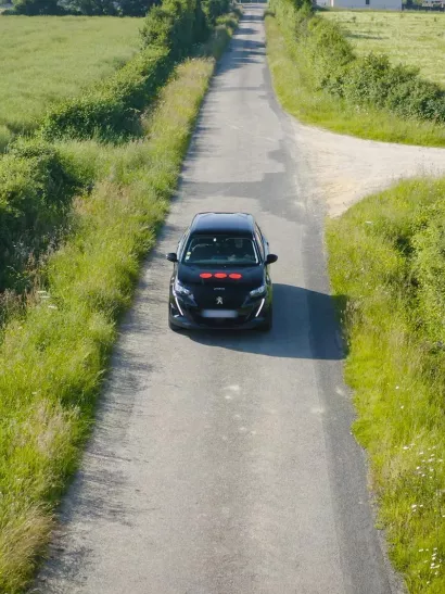 a car with the Securitas Technology logo driving down a road, showcasing the company's mobile service capabilities and rapid response commitment.