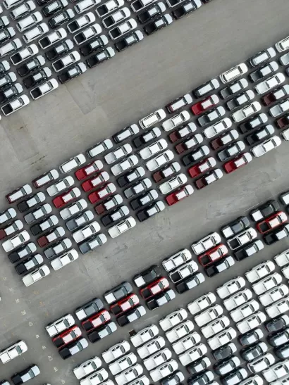 aerial top down view of a parking lot new cars lined up in the port for import and export international.