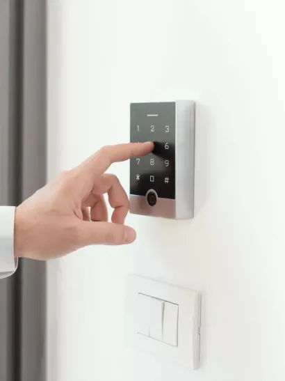 Man setting an alarm code for home security, alarm system concept