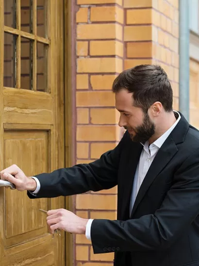 Man locks large wooden door