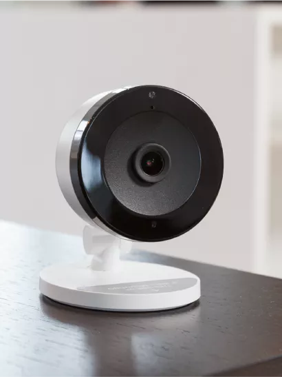 Three images of various home security cameras.