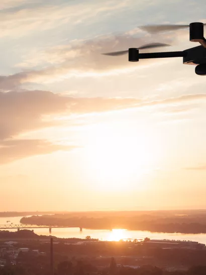 Drone in sunset above city