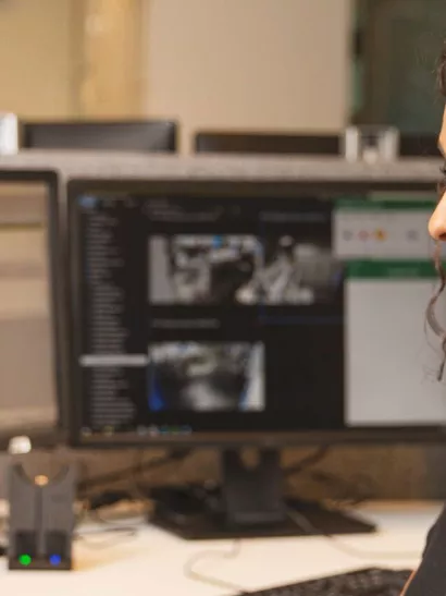 A female Alarm Monitoring agent looking at a computer screen 