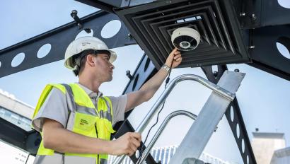 security technician installing business security camera
