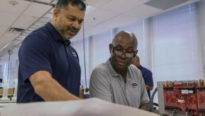 Manager and engineer talking in lab.