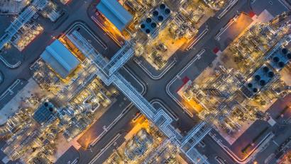 Aerial top view oil and gas refinery plant form industry zone at night.