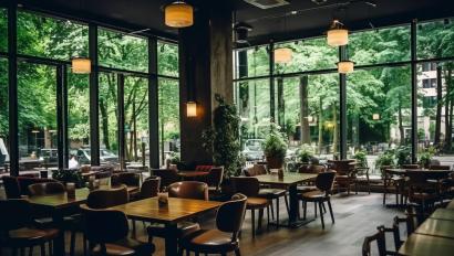 Large spacious empty cafe or restaurant with huge windows overlooking the garden.