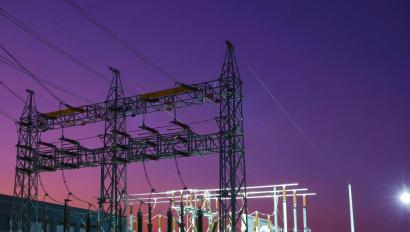 An electricity substation at night that requires physical security for critical infrastructure protection and energy security