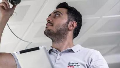 Securitas technician installing a security camera