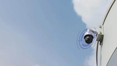 AI-powered outdoor dome security camera mounted on a building exterior, monitoring a commercial property with intelligent video analytics for real-time threat detection and surveillance efficiency