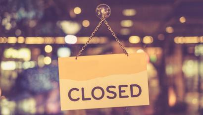 Closed sign hanging in shop window