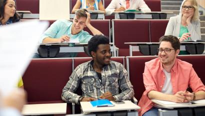 Students sit in a lecture hall waiting for class to start