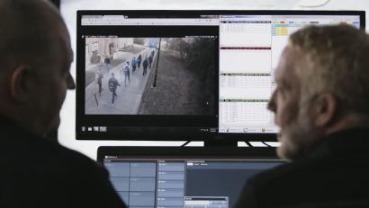 Security employees monitor school video feed