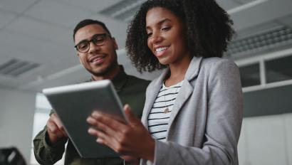 Two business people consult tablet