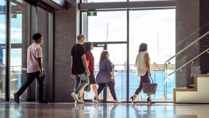 People walking through building lobby