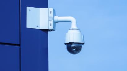 Video camera mounted on blue building