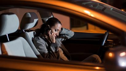 Woman calls on cellphone in parked car