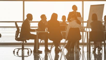 employees meeting by a large window