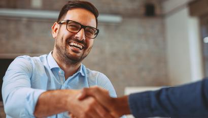 Smiling man shakes hands