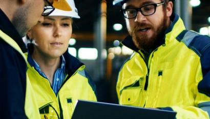 Employees look at tablet display