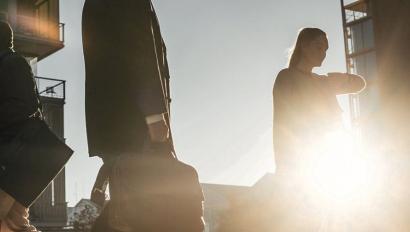 People walking with sun behind