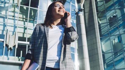 Smiling woman speaks into cellphone