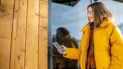 Woman using keyless access control on her smartphone.