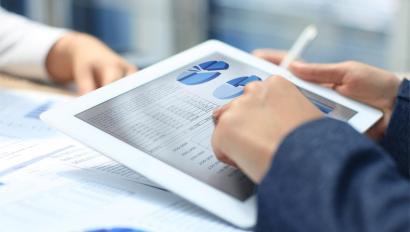 Person uses tablet to view data analysis report.