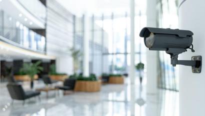 security camera installed on wall overlooking office setting 