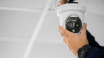 Technician installing IP wireless CCTV camera by screwed for home security system and installed